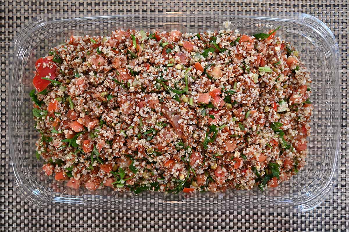Image of the tray of the Costco Kirkland Quinoa Salad with the lid off, on a table, top down image.