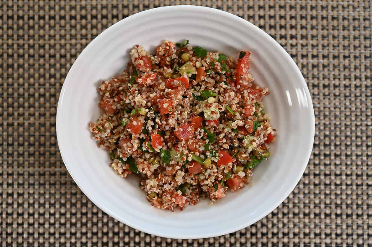 Bowl of Costco Kirkland Quinoa Salad on a placemat on a table, top down image.