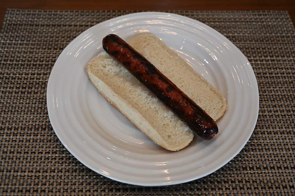 Costco Kirkland Signature Beef Wiener on a hot dog bun on a white plate. 