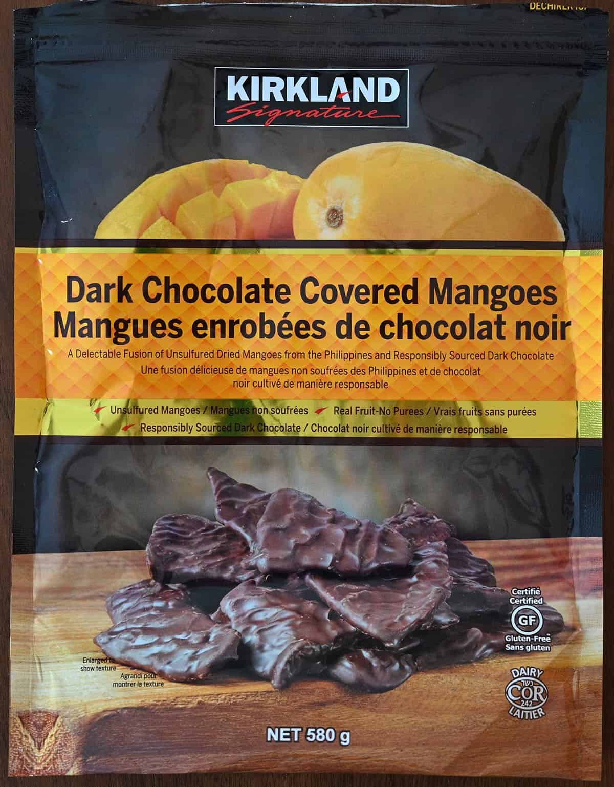 Closeup image of the bag of Costco Kirkland Signature Dark Chocolate Covered Mangoes. 