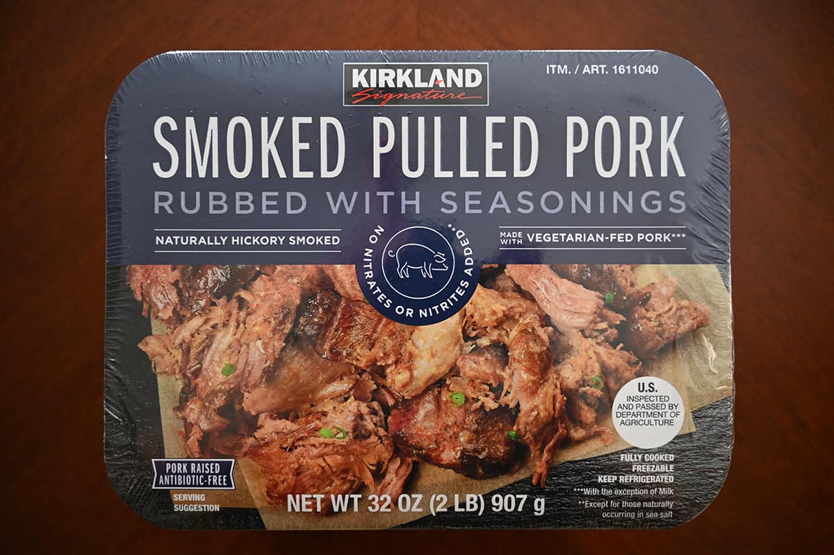Top down image of the Kirkland Signature Smoked Pulled Pork package unopened sitting on a table.