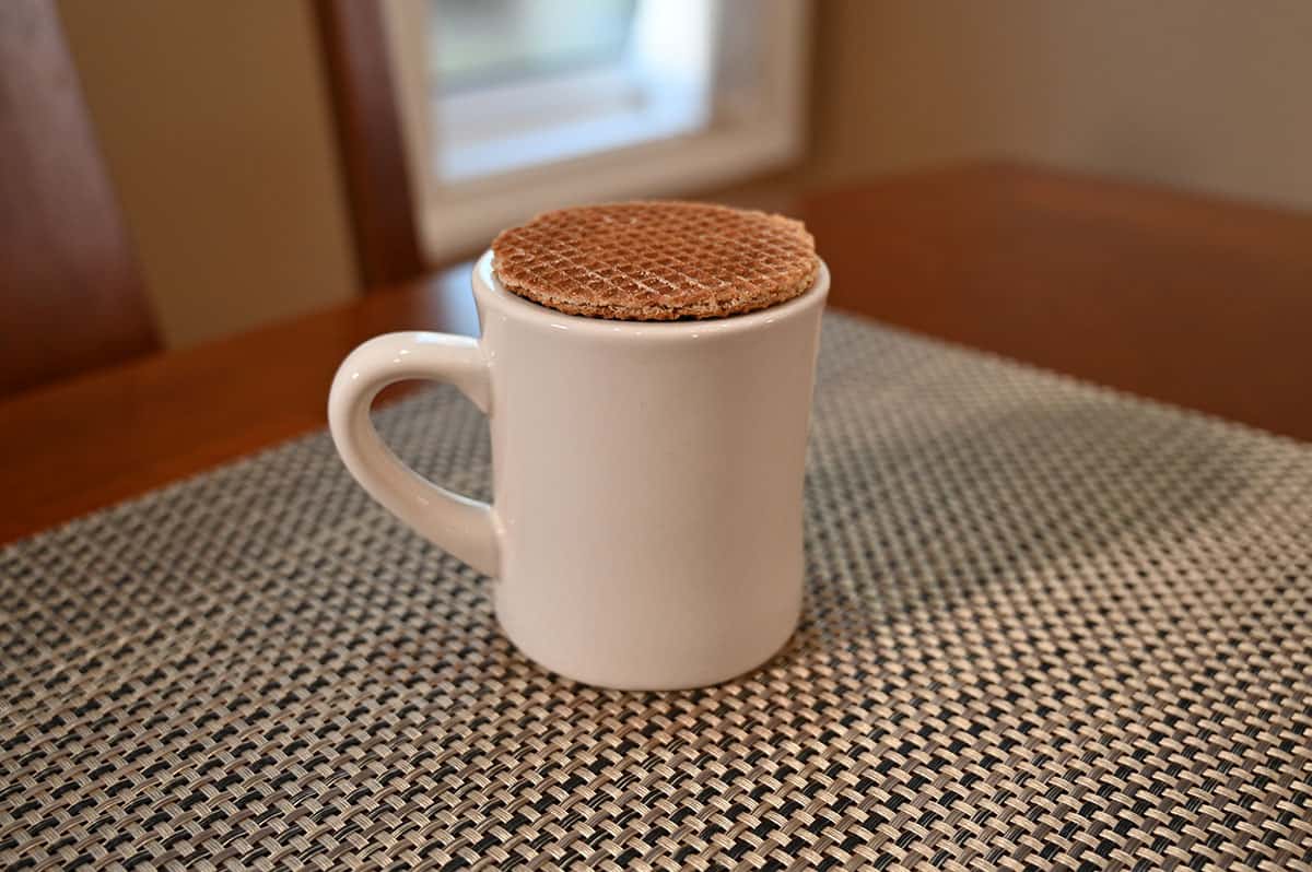 Image of a stroopwafel cookie sitting over top a white mug.