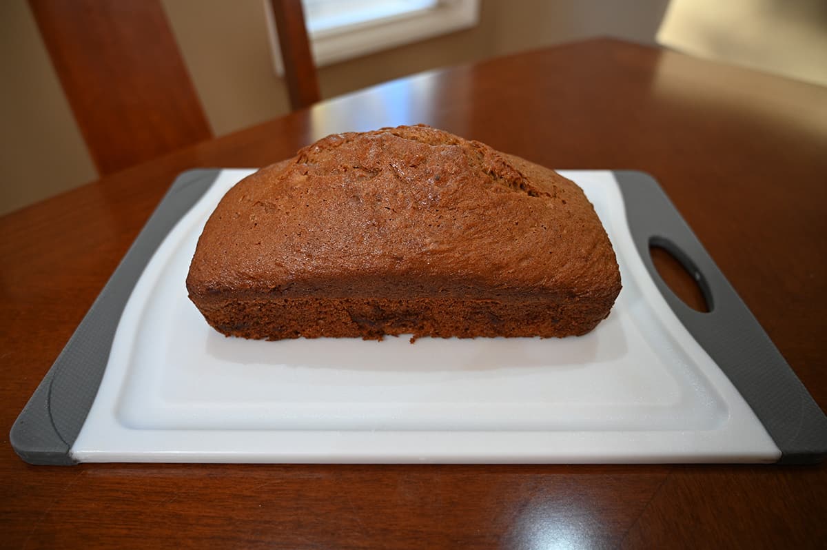 Sideview image of a whole pumpkin spice loaf on a cutting board.