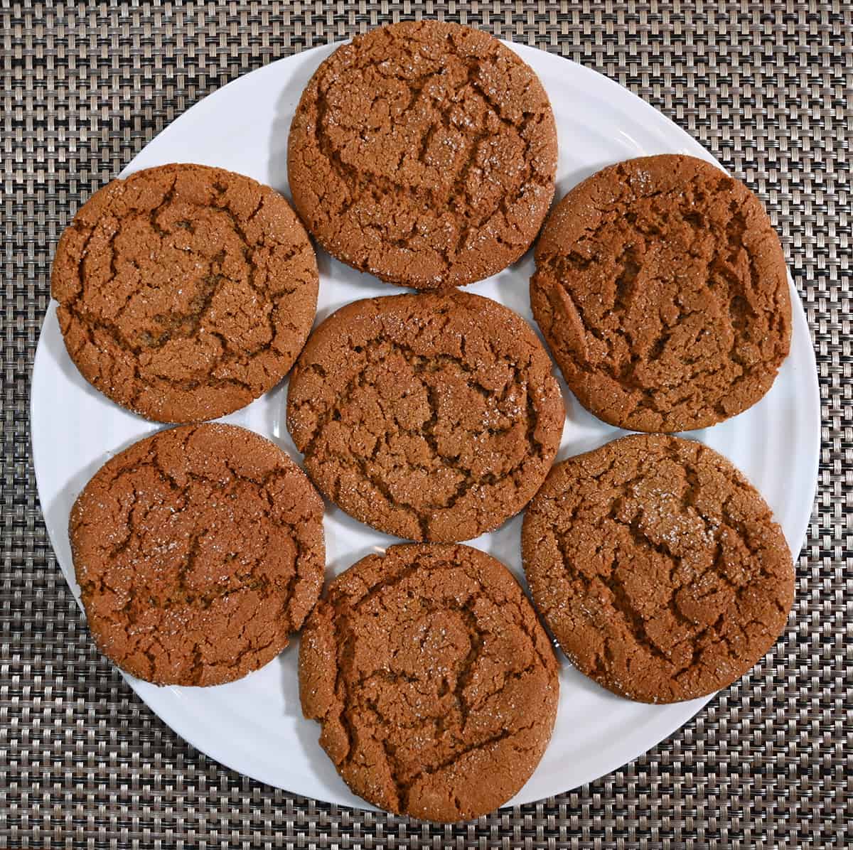 Top down image of a plate of ginger cookies sitting on a table.