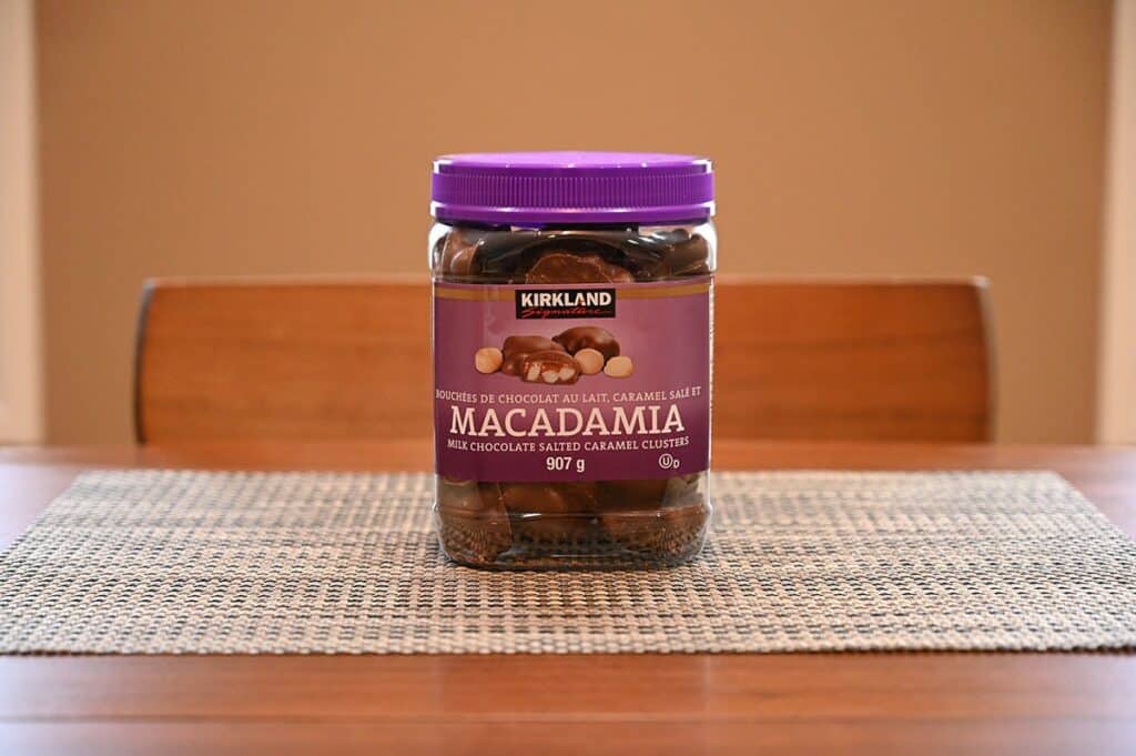 Sideview image of the Costco Kirkland Signature Macadamia Clusters container sitting on a table 