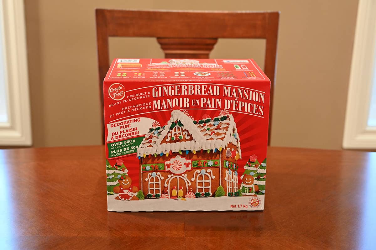 Image of the Costco Create A Treat Pre-Built Gingerbread Mansion Kit box sitting on a table.