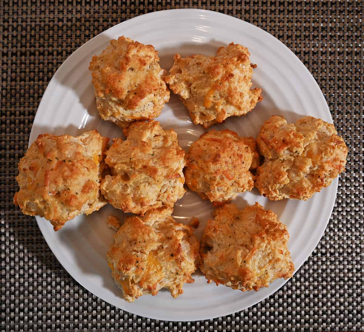 Top down image of a plate of baked biscuits.