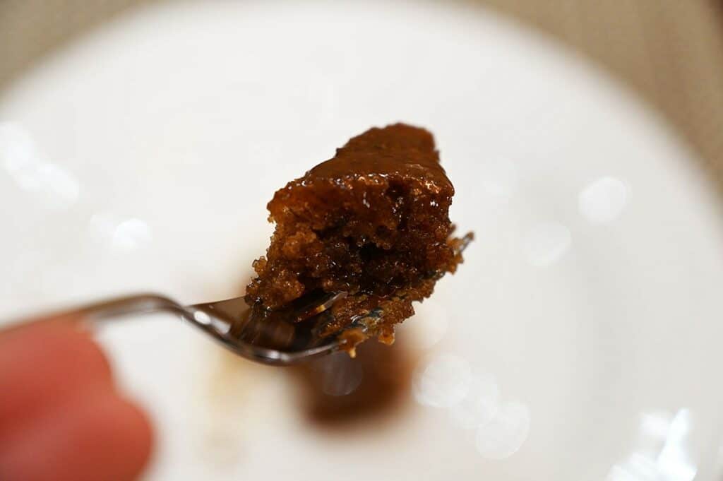 Closeup image of a bite of the Top down image of the Costco The Sticky Toffee Pudding Co. Sticky Toffee Pudding on a fork. 