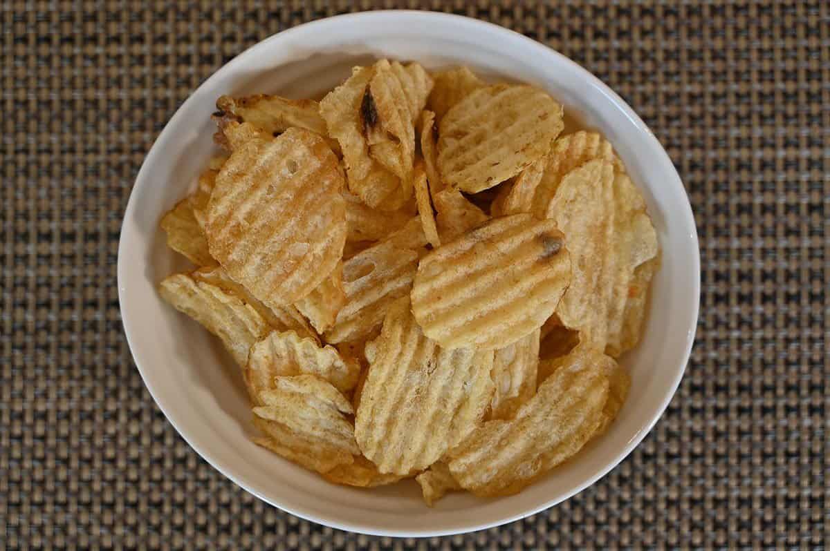 Costco Kirkland Signature Kettle Brand Potato Chips poured into a white bowl, top down image. 