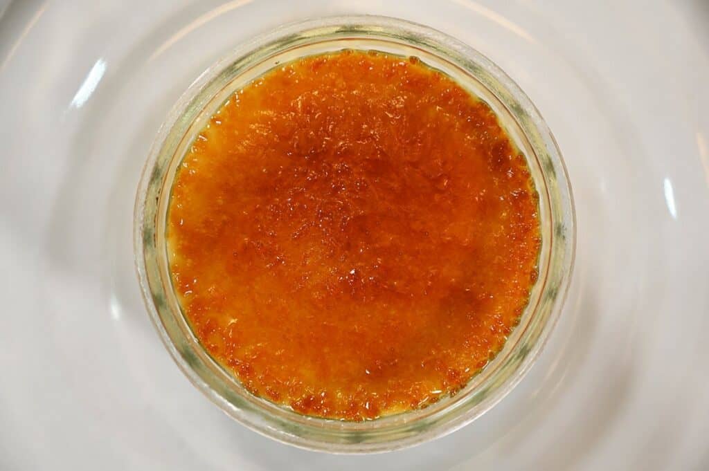 One prepared Costco Marie Morin Crème Brûlée showing the top caramelized sugar, close up image. 