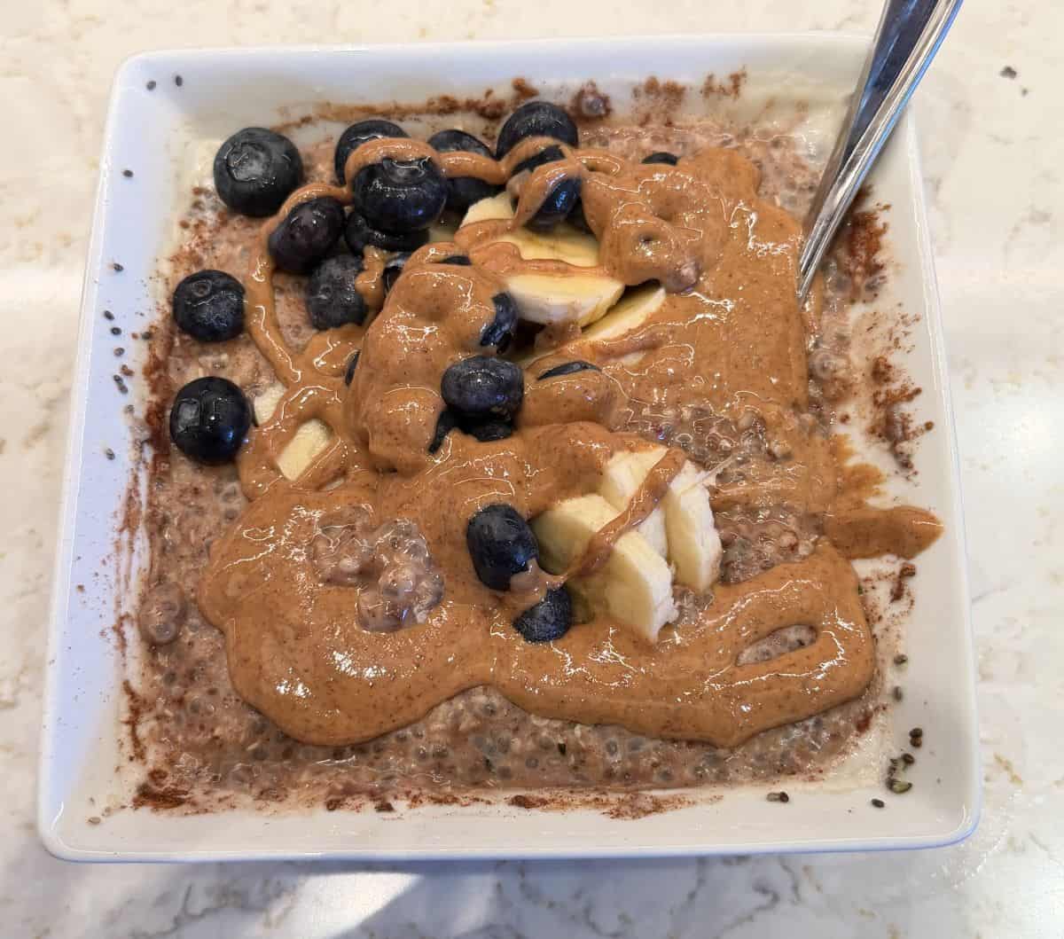 Image of the almond butter drizzled on top of a bowl of oatmeal.