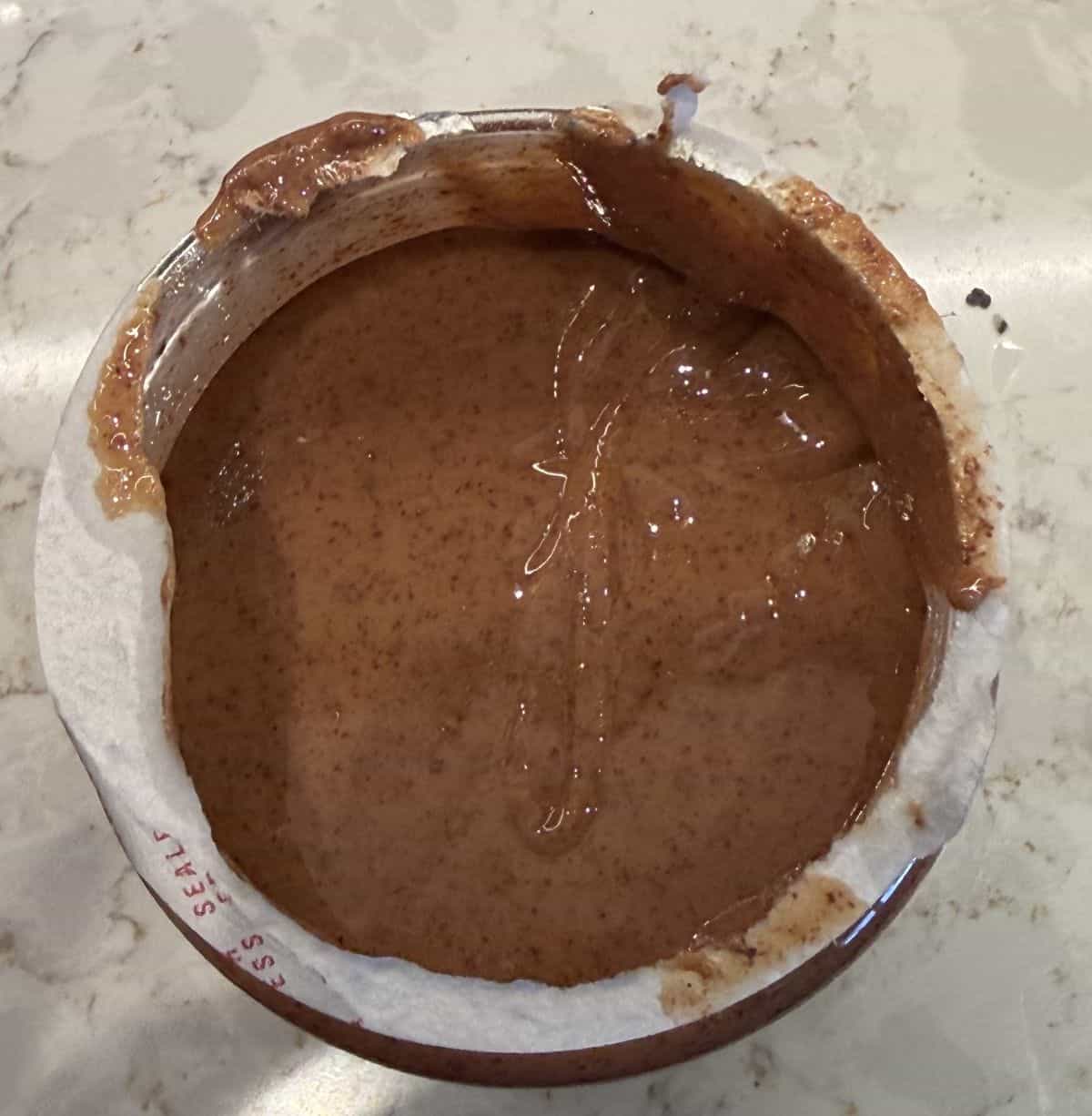 Image of the top of the almond butter jar with the lid off after being stirred.