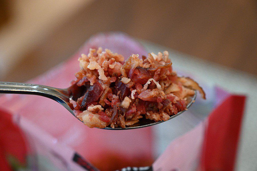 Closeup of a spoonful of the Costco Kirkland Signature Bacon Crumbles. 