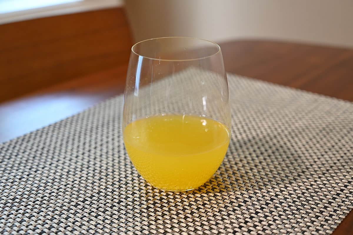 One glass of Costco Mamamango Mango Moscato sitting on a table. 