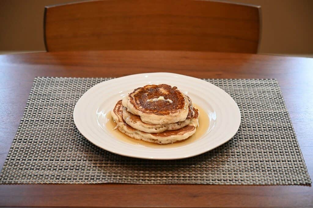 Costco Krusteaz Buttermilk Pancake Mix  stack of prepared pancakes on a plate with syrup. 