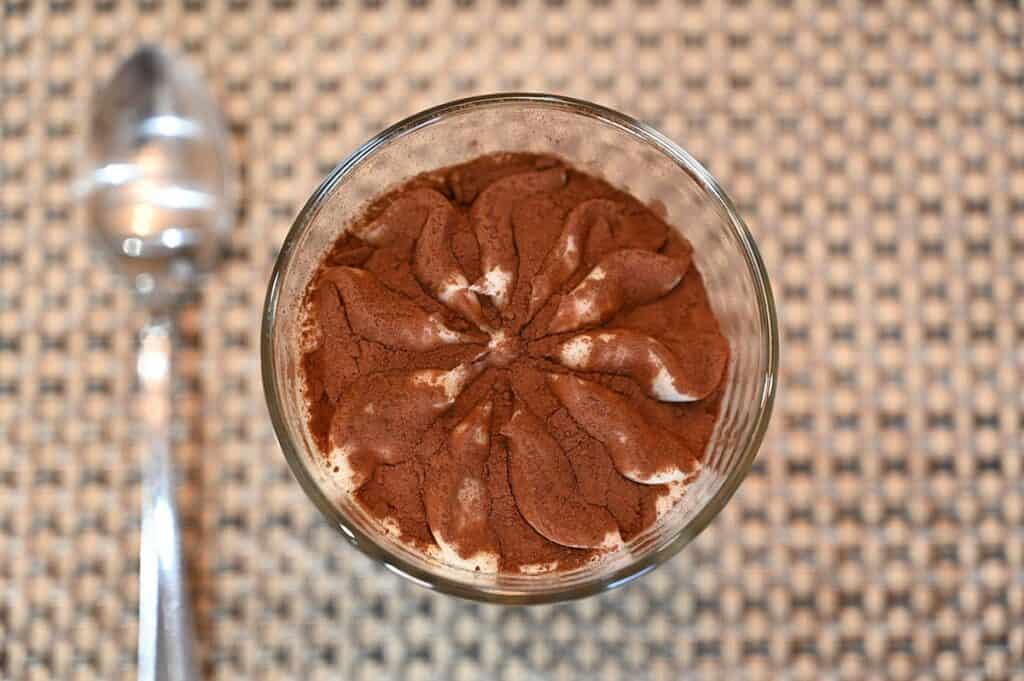 top down image of the Costco Dessert Italiano Tiramisu Cup with the lid off showing cocoa powder dusted on the top 