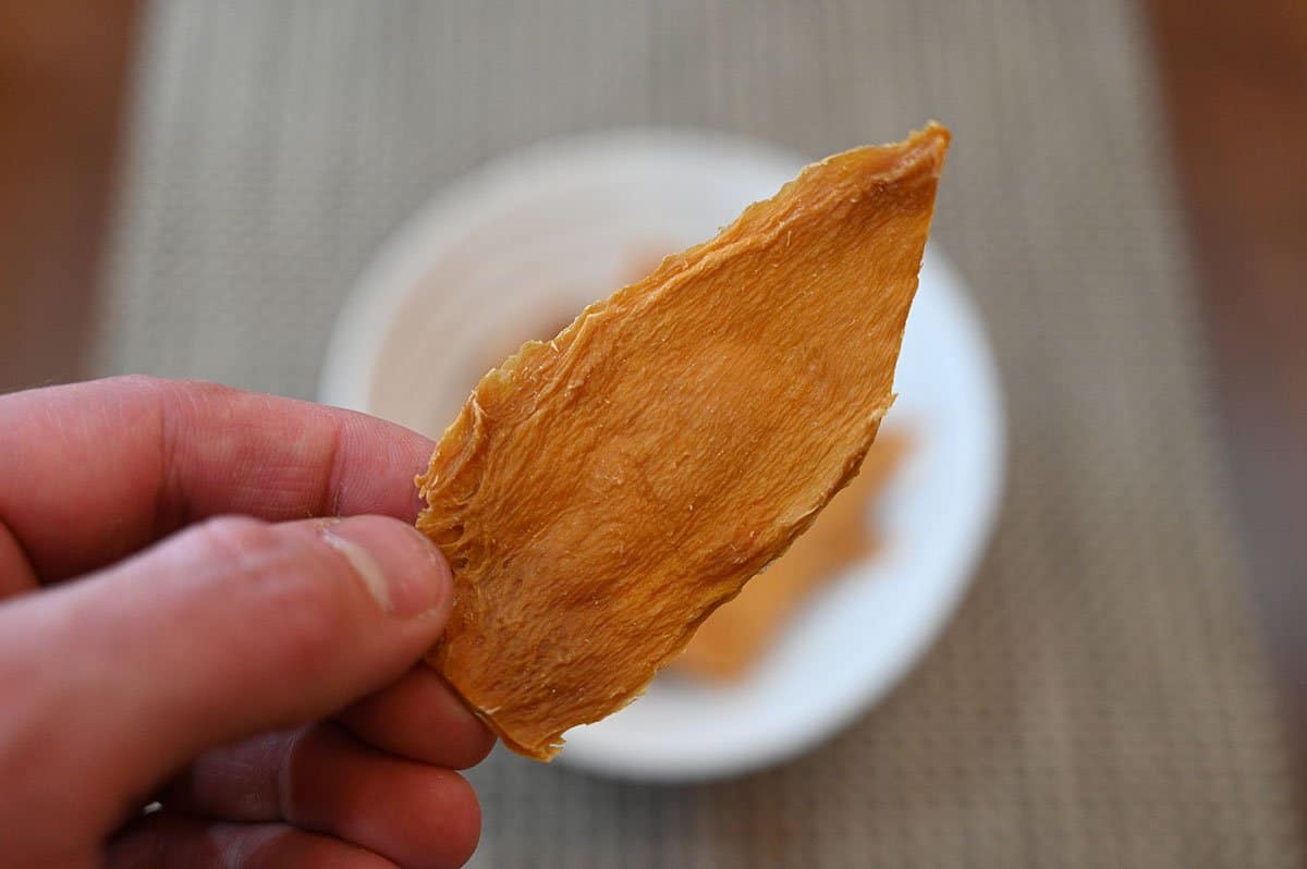 Close up image of one different piece of Costco Kirkland Signature Organic Dried Mango piece.