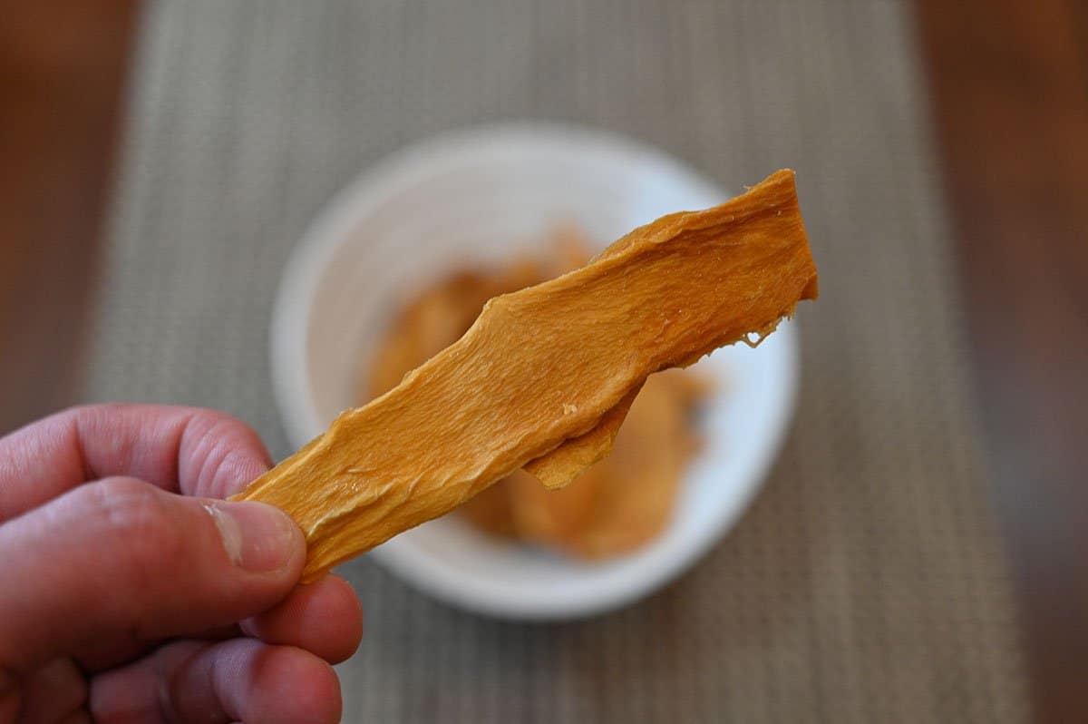 Close up image of one Costco Kirkland Signature Organic Dried Mango piece. 