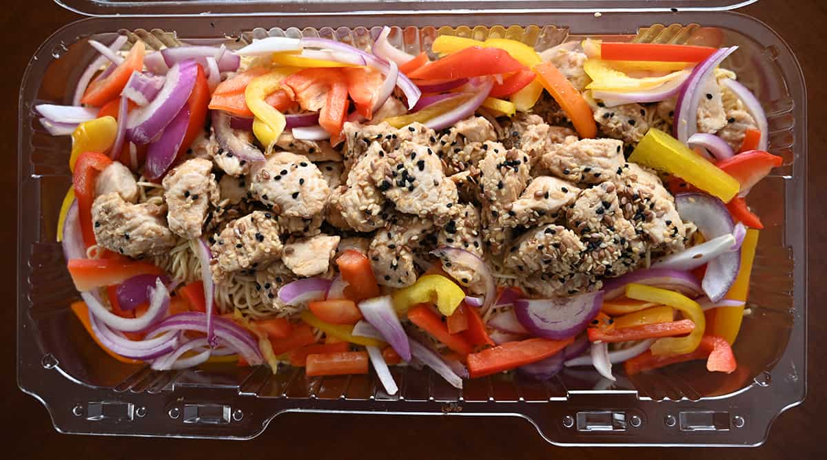 Top down image of the chicken chow mein tray opened so you can see the chicken, peppers and noodles.