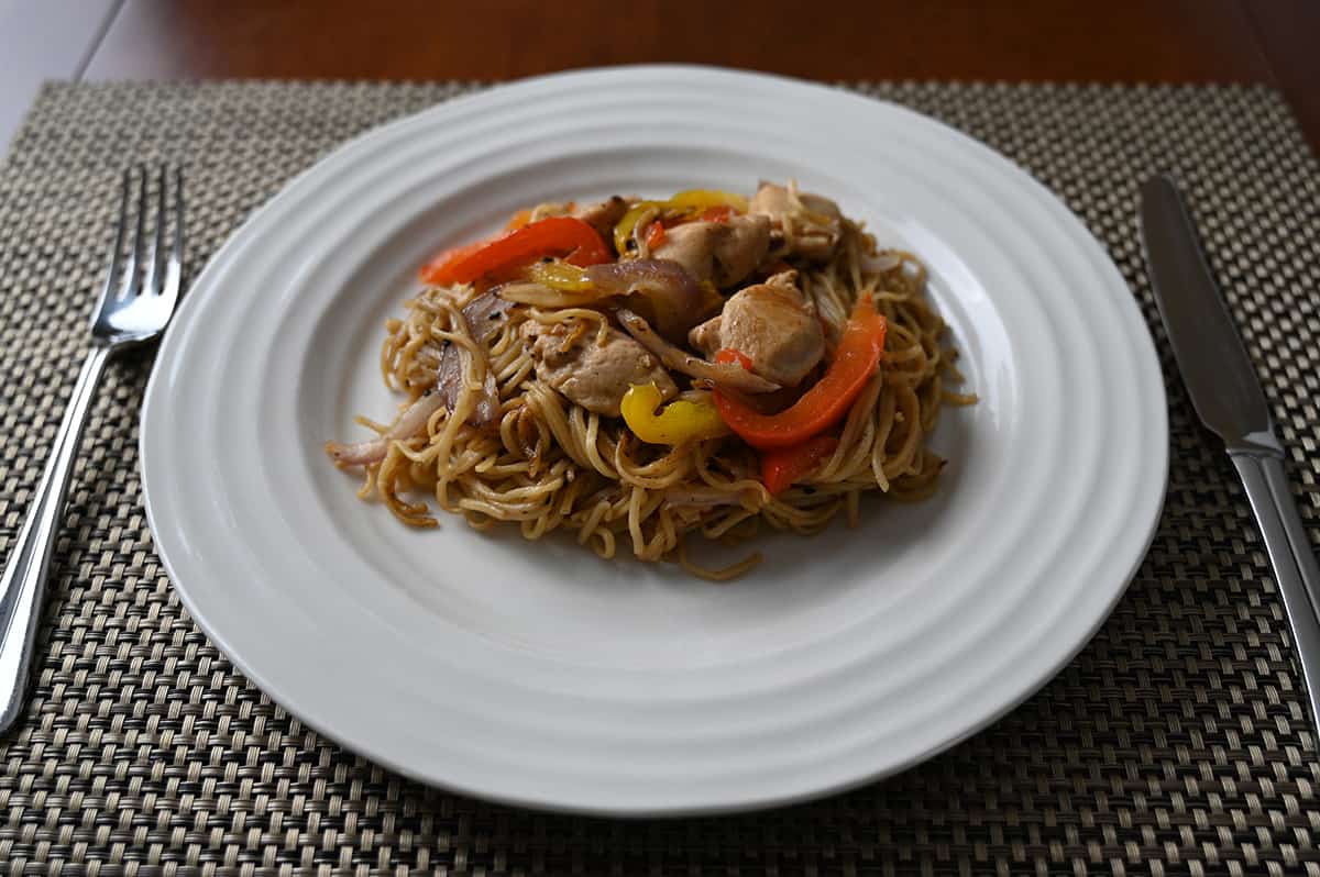 Sideview closeup image of a plate of chicken chow mein.