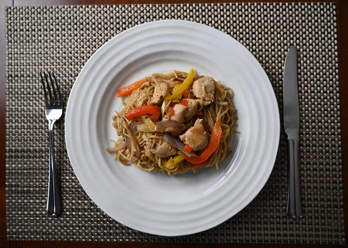 Top down closeup image of a plate of cooked chicken chow mein.