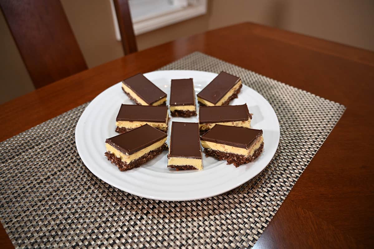 Image of Nanaimo bars cut and served on a white plate. 