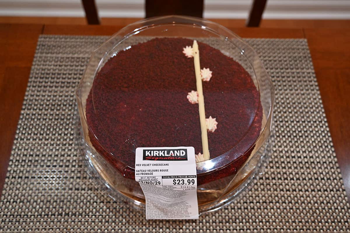 Costco Kirkland Signature Red Velvet Cheesecake sitting on a table inside the packaging, top down image. 
