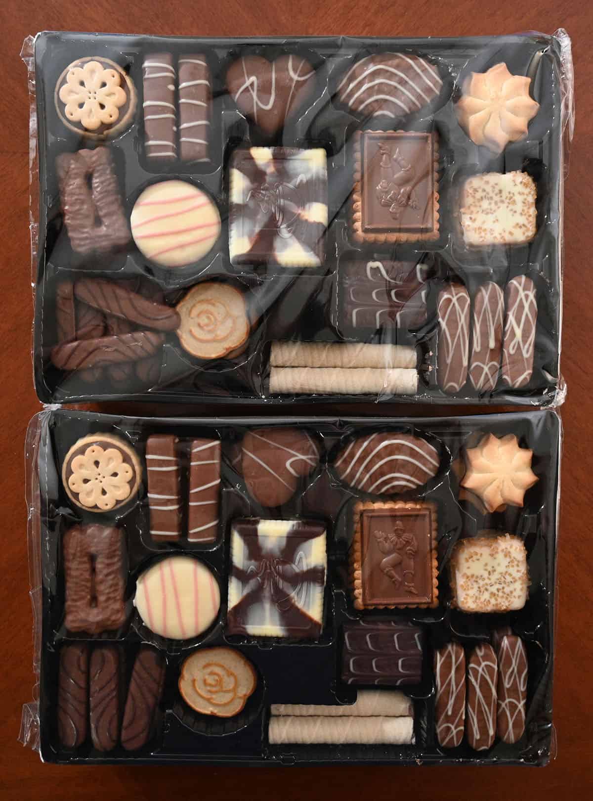 Top down image of the cookies in their plastic tray with plastic wrap on top.