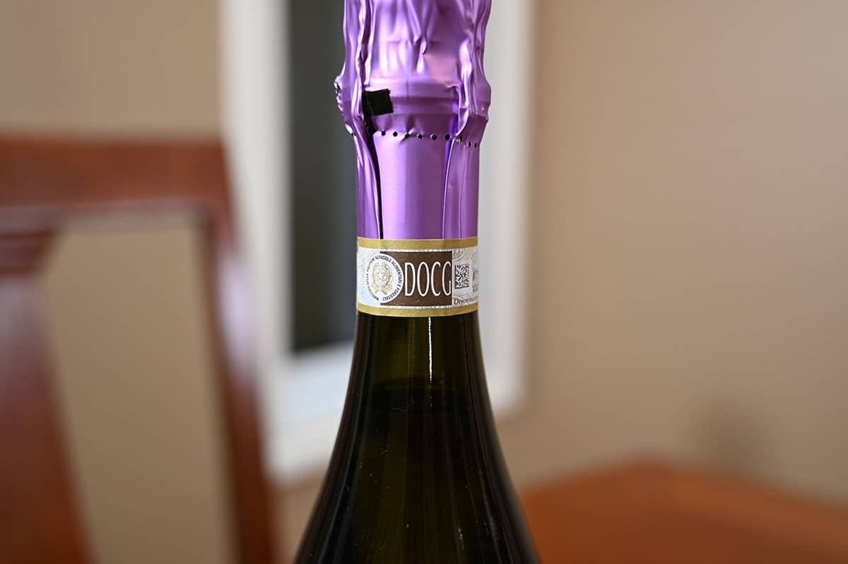 Closeup image of the prosecco cork wrapped in foil that says "DOCG".