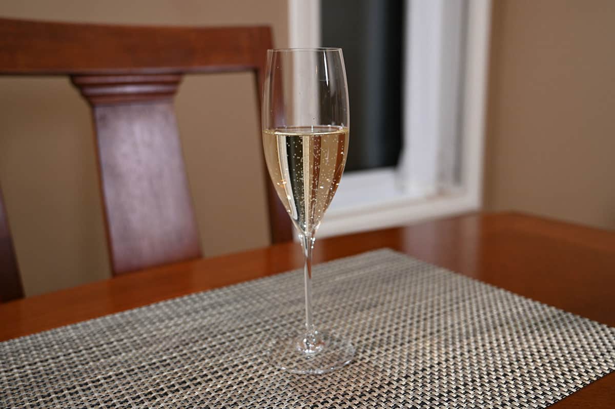 Side view image of a poured glass of prosecco.