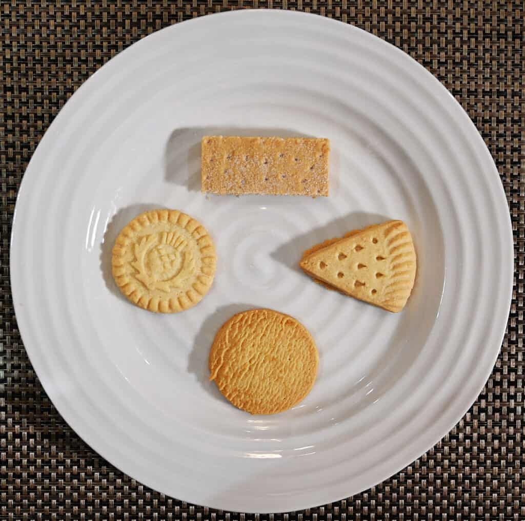Image of the four different kinds of shortbread served on a white plate, four cookies shown.