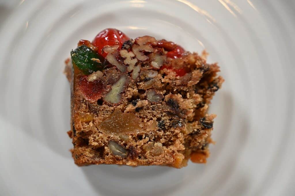 Closeup image of the Costco Kirkland Signature Christmas Fruit Cake slice sitting on a plate 