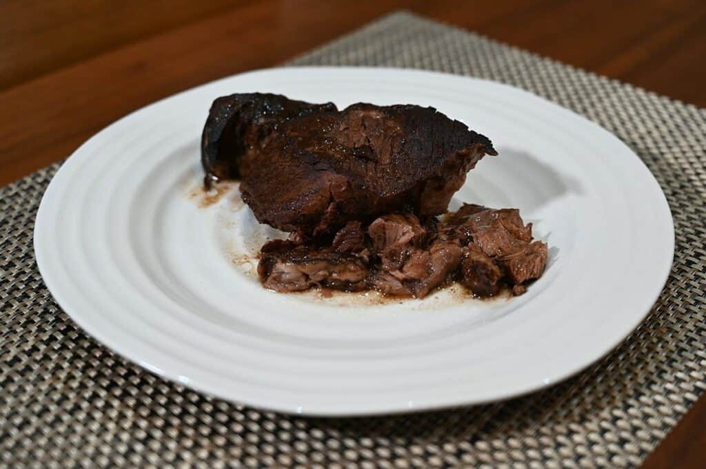 Costco 44th Street Beef Pot Roast entire cooked pot roast plated on a white plate sideview image. 