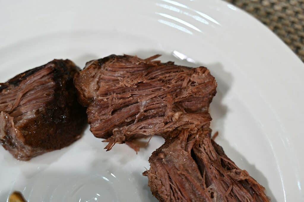 Costco 44th Street Beef Pot Roast closeup image of pieces of beef on a white plate. 