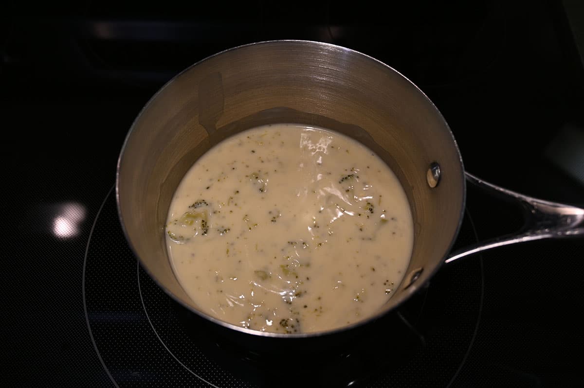 Image of a saucepan with soup in it cooking on the stovetop.