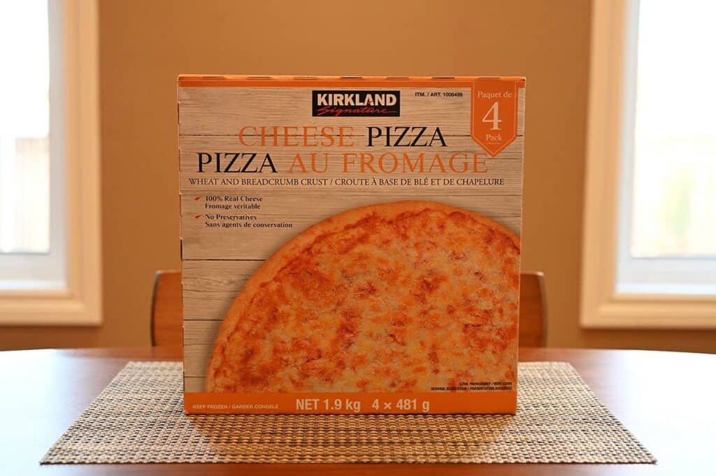 Image of the Costco Kirkland Signature Frozen Cheese Pizza box sitting on a table 