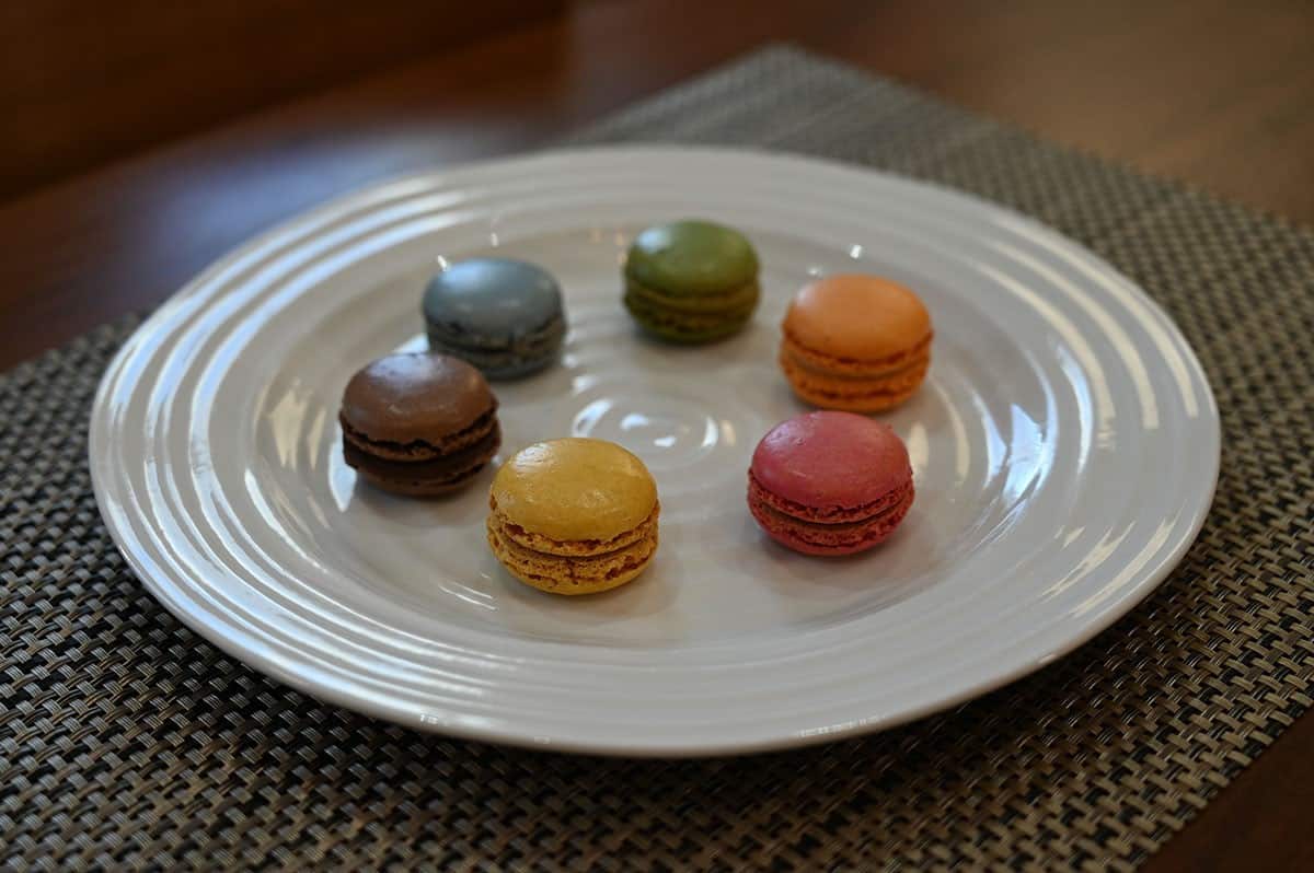 All six flavors of the macarons on a white plate. 