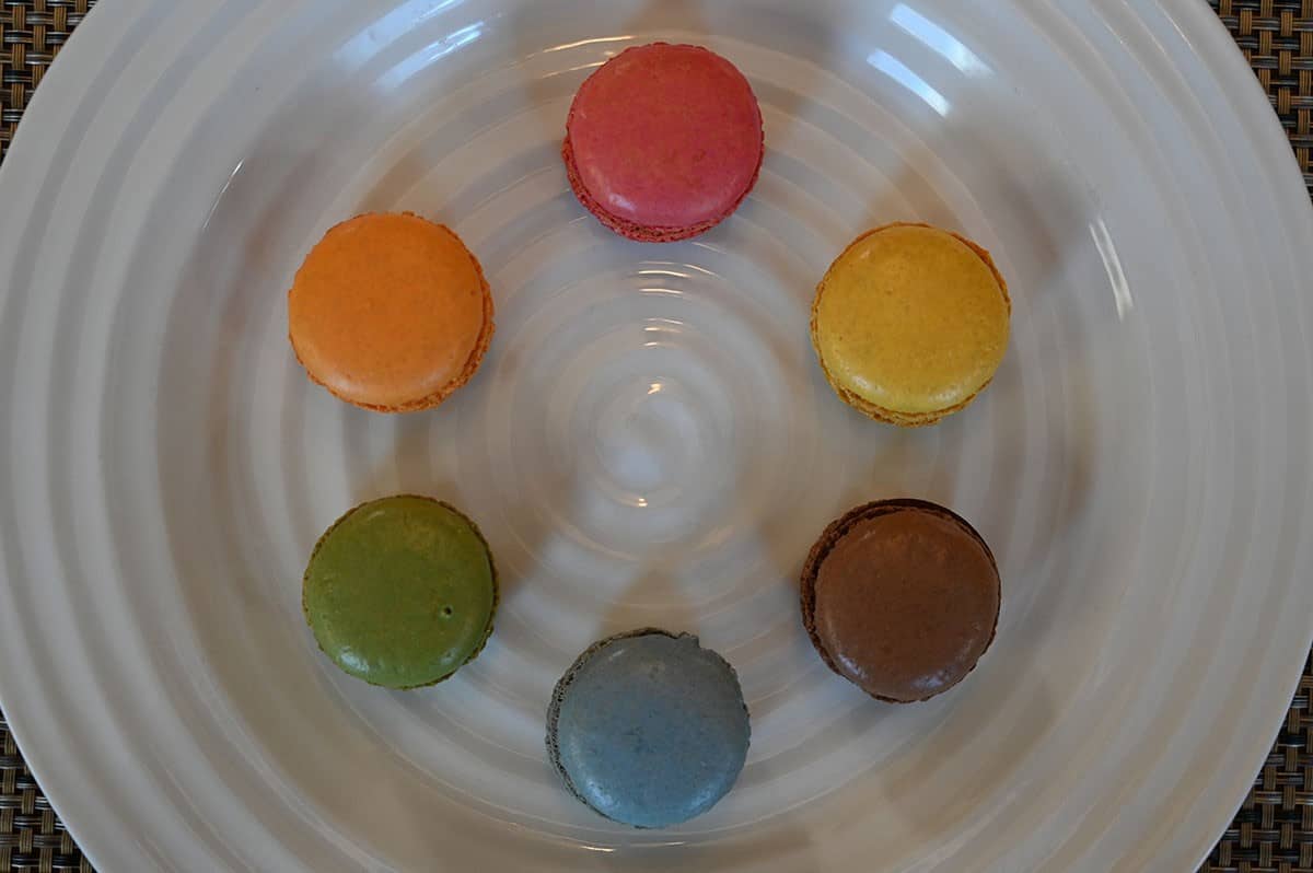 Top down image of the six kinds of macarons on a white plate. 