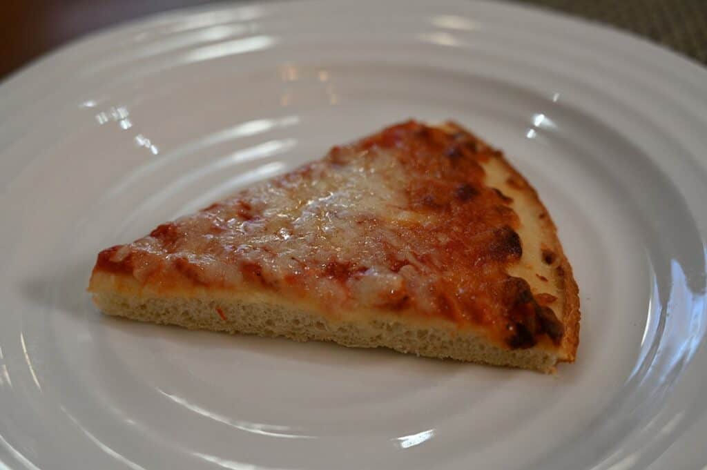 Image of one slice of the Costco Kirkland Signature Frozen Cheese Pizza  on a plate