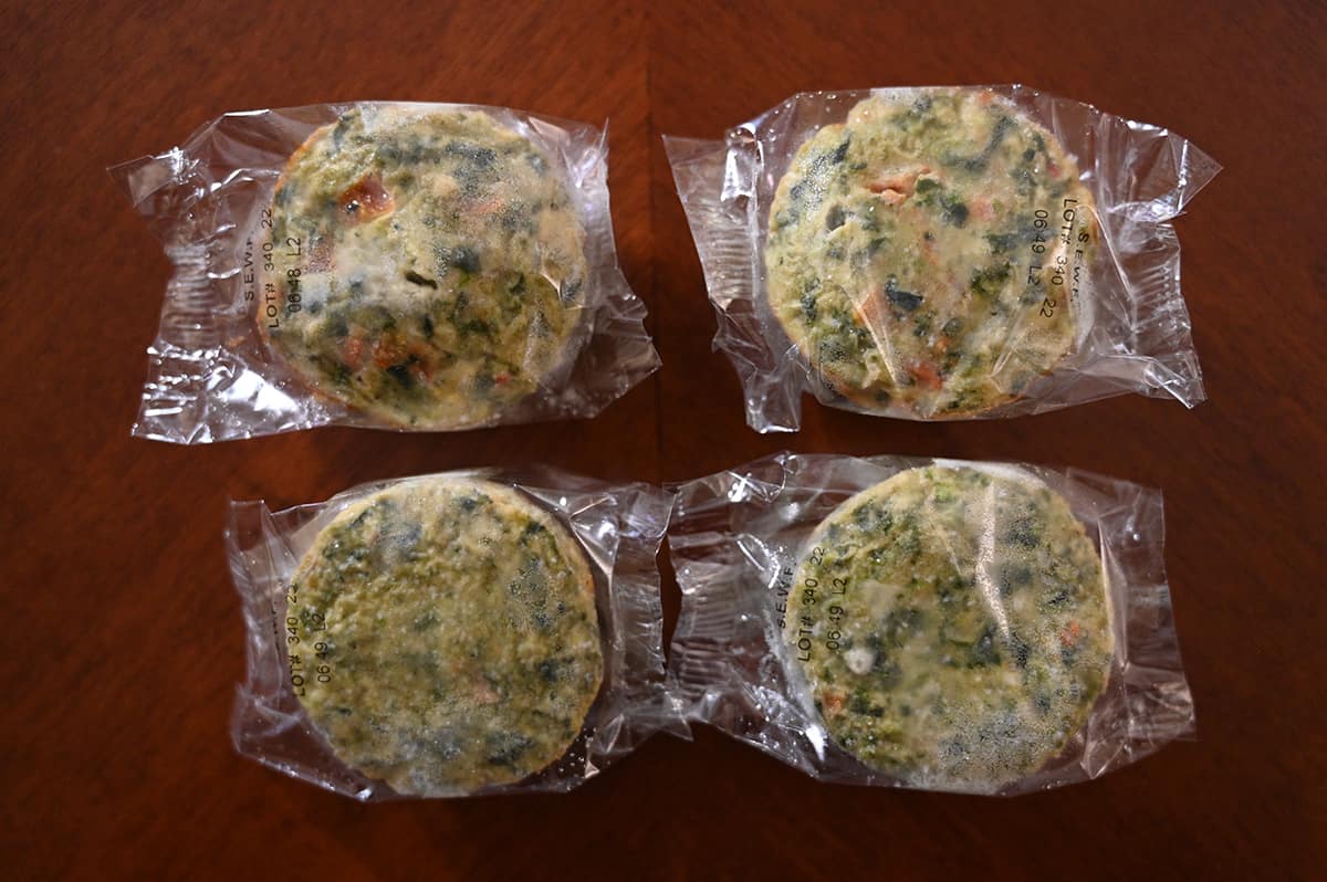Top down image of four individually packaged frittatas.