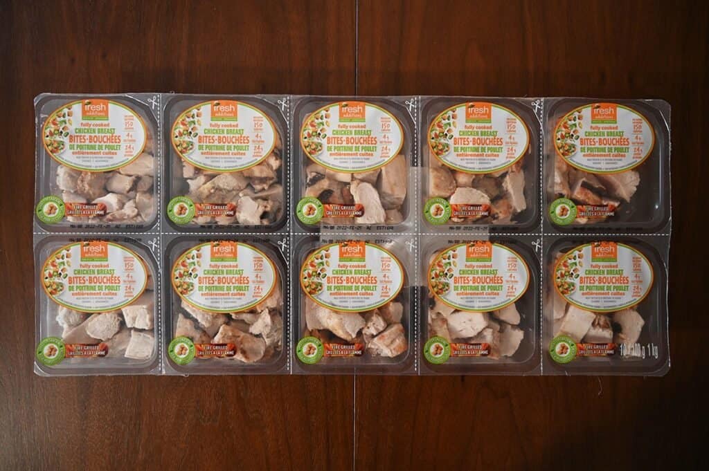 Costco Fresh Additions Fully Cooked Chicken Breast Bites in package sitting on a table. Ten small packs visible. 
