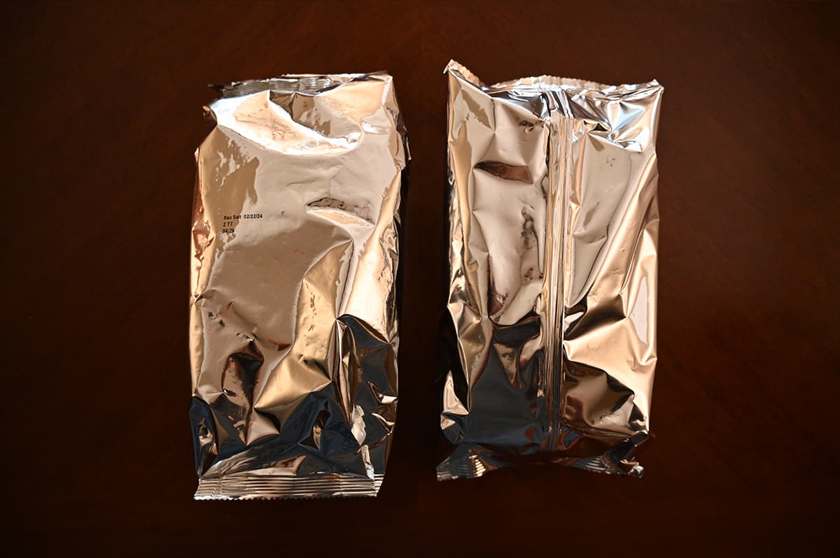 Top down image of two plastic bags of crackers sitting on a table unopened.