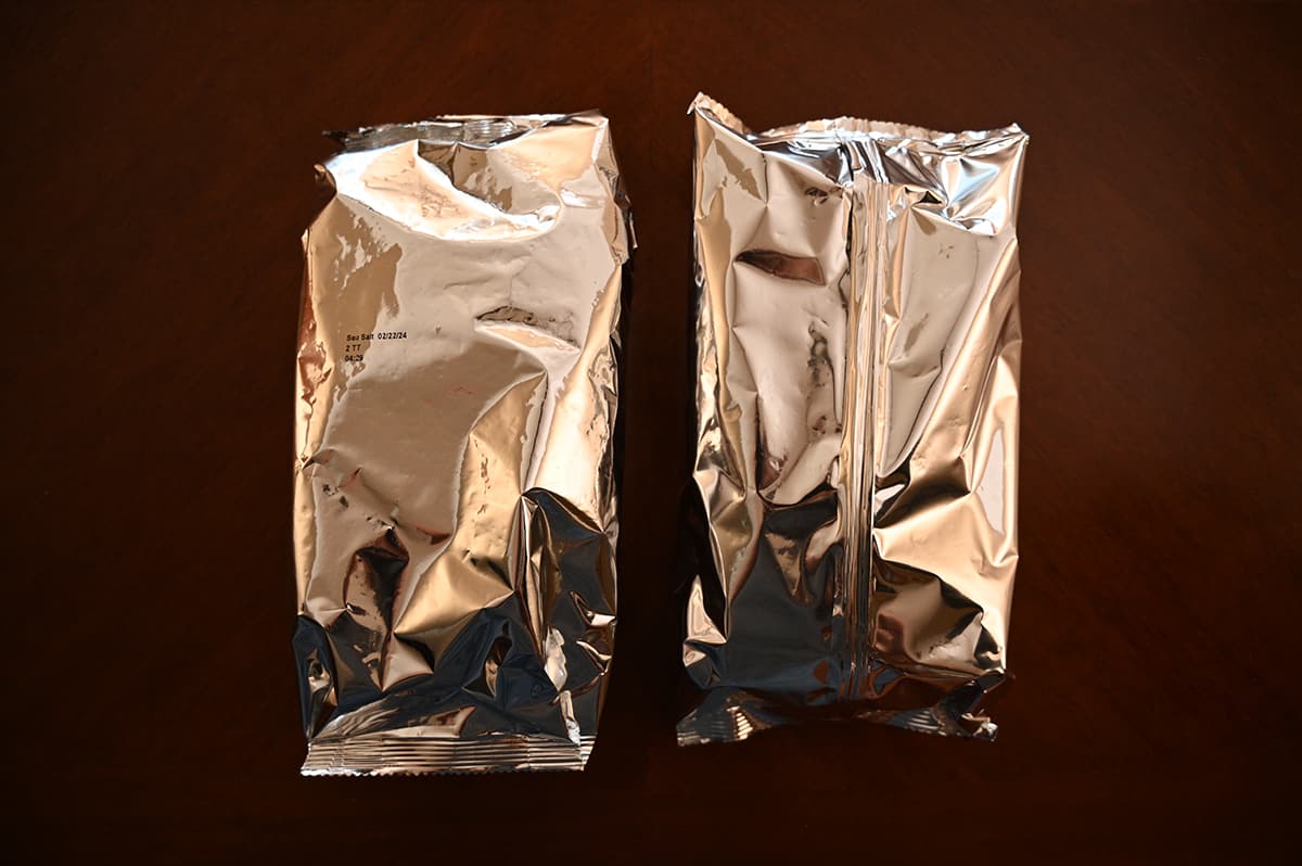 Top down image of two plastic bags of crackers sitting on a table unopened.