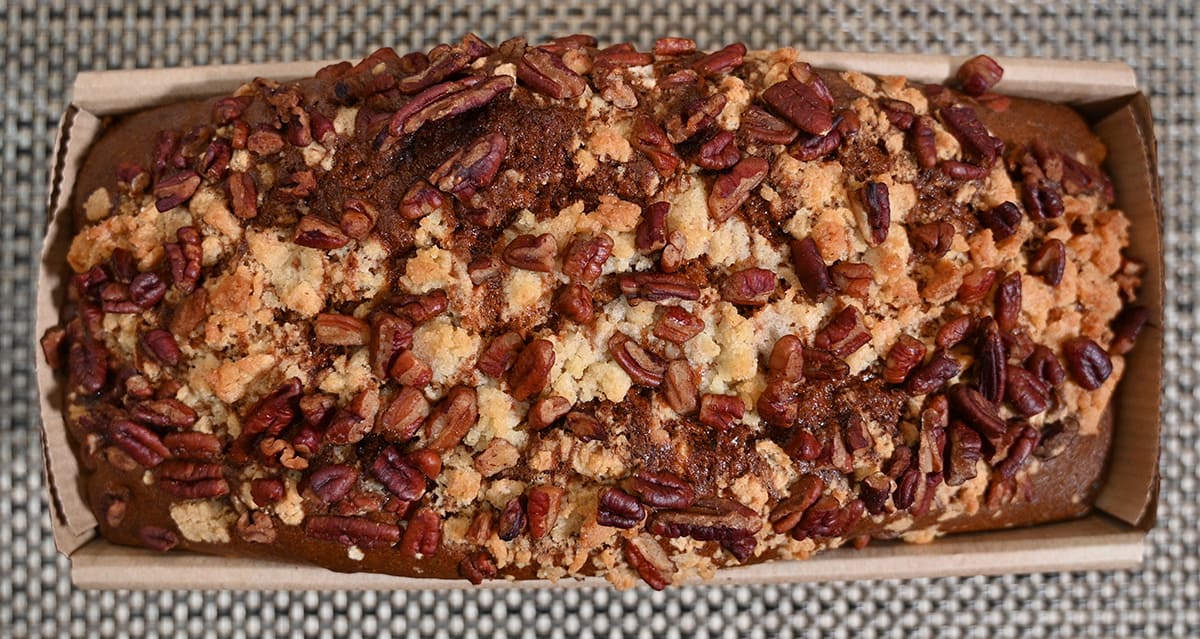 Top down image of the banana pecan loaf with the lid off so you can see the top of the loaf in the container.