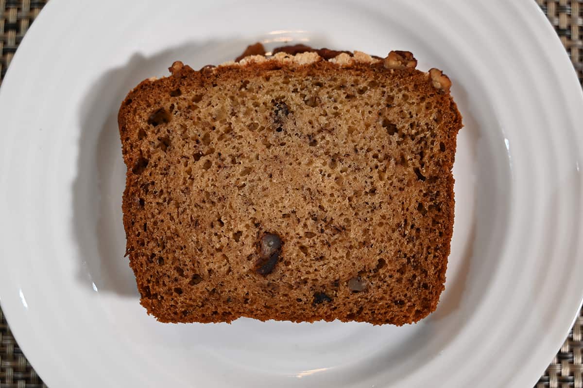 Top down image of one slice of Costco banana bread on a white plate.