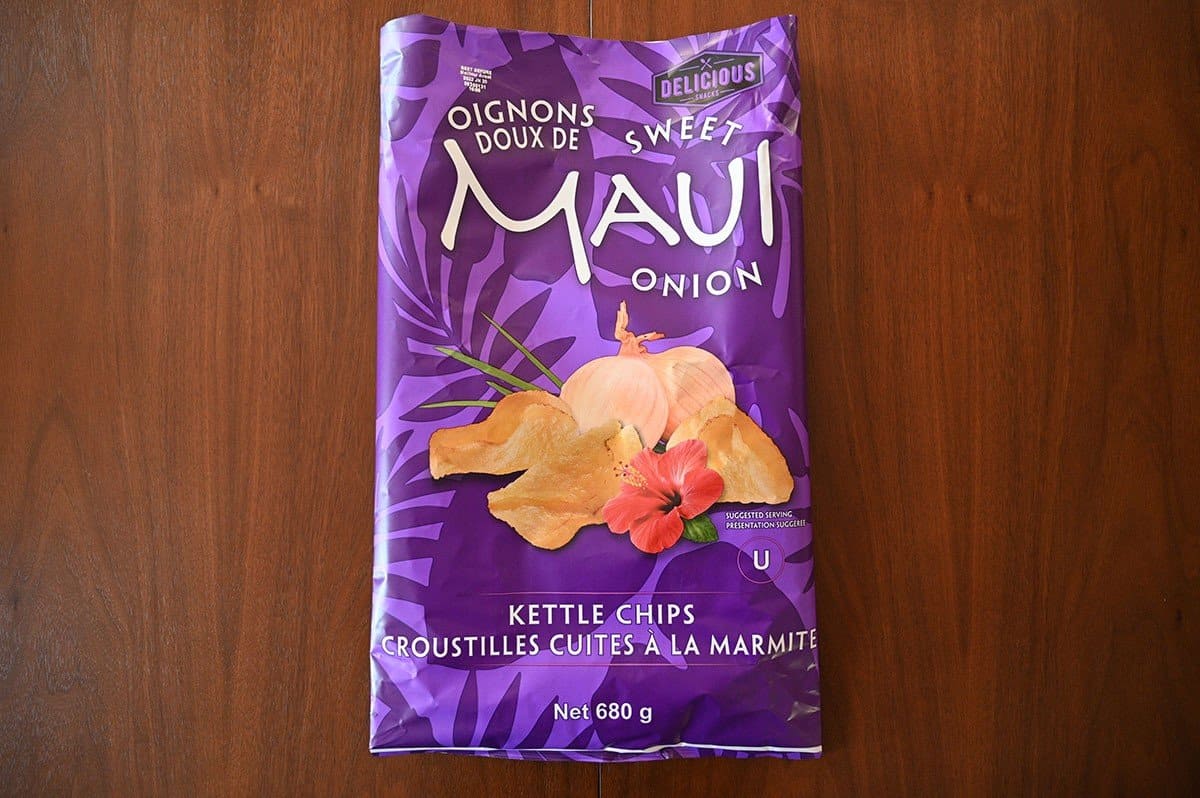 Image of Costco Delicious Snacks Sweet Maui Onion Kettle Chips flattened and empty on a table. 