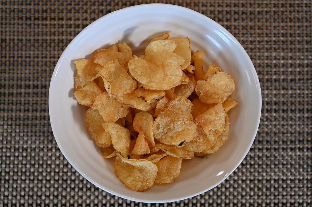 Costco Sweet Maui Onion Kettle Chips poured into a white bowl. 