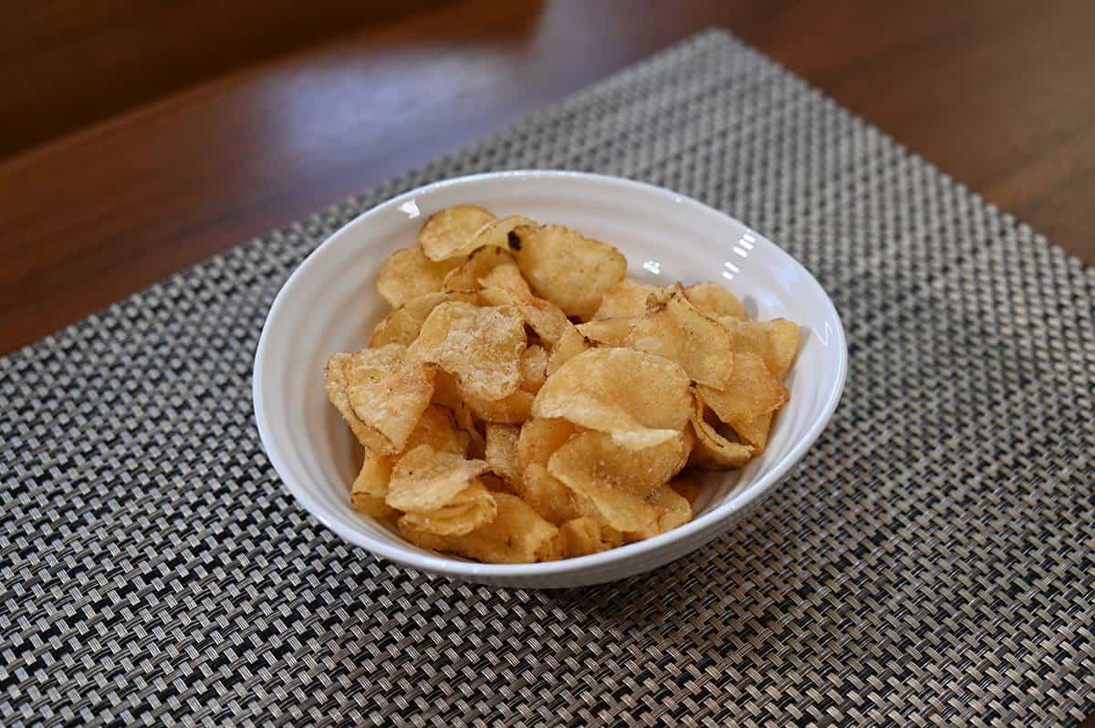 Costco Sweet Maui Onion Kettle Chips poured into a white bowl. 