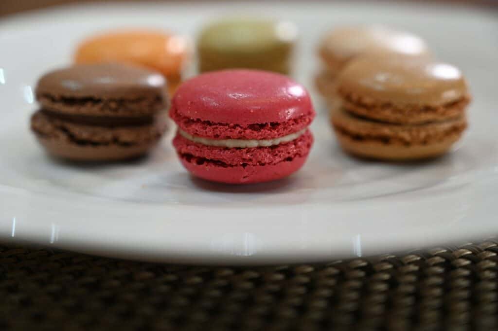 Side closeup image of the six flavors of Costco Tipiak French Macarons on a plate 