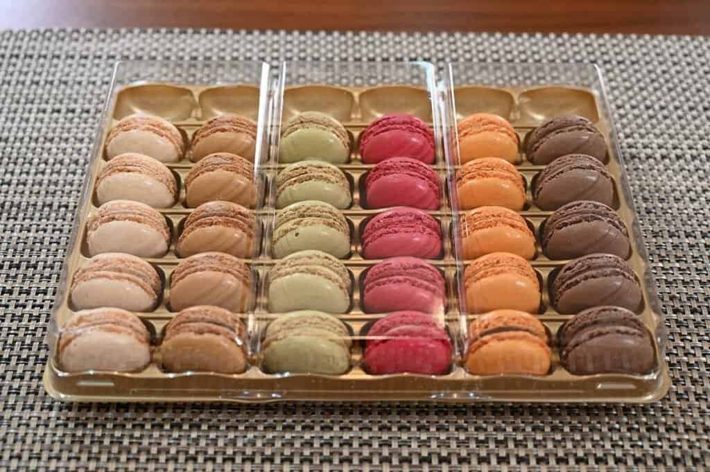 Top down image of the Costco Tipiak French Macarons box opened showing the macarons sitting neatly in rows by flavor
